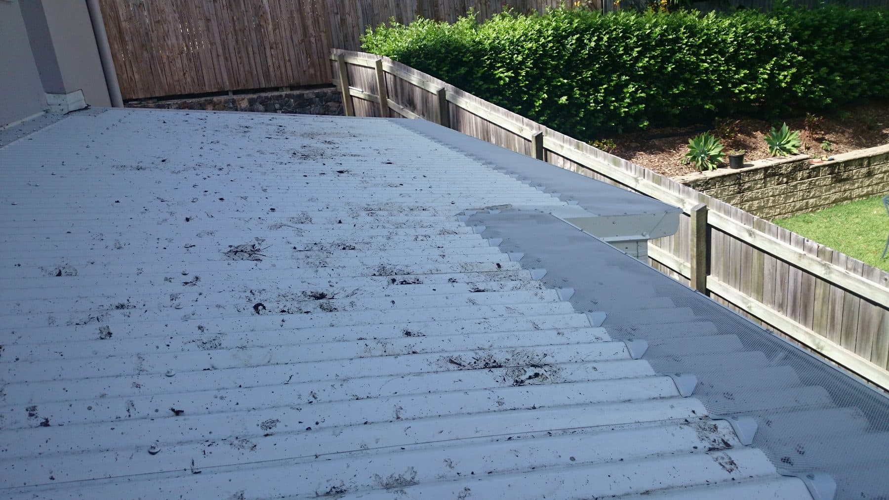 A gutter packed with leaves and debris before a free clean and gutter guard install